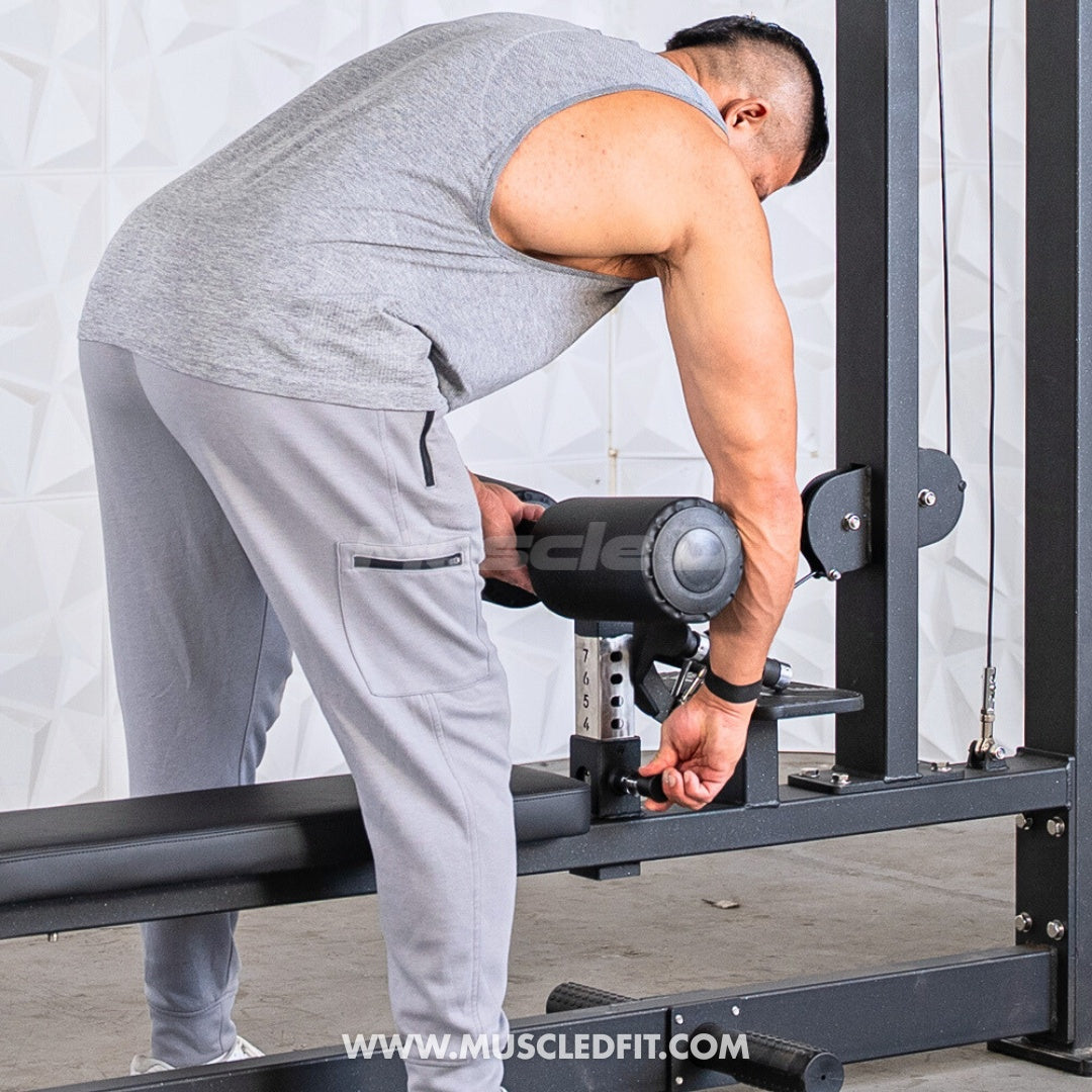 Man adjusting weights on a Classic V2 Lat Pulldown Low Row Combo machine with a blurred background