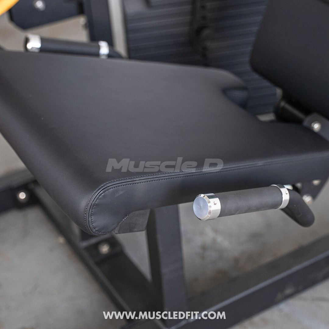 Classic V2 Selectorized Leg Extension / Seated Leg Curl Combo with 'Muscle D' branding on a concrete floor.