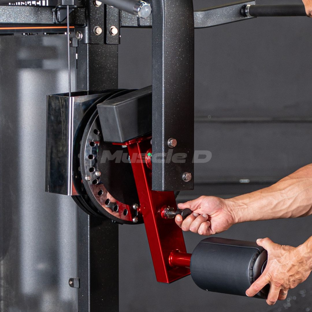 Person adjusting a weight plate on a Classic V2 Multi Hip machine with 'Muscle D' branding.