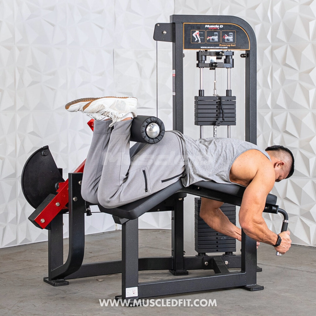 Person using a Classic V2 Prone Leg Curl machine in a gym setting