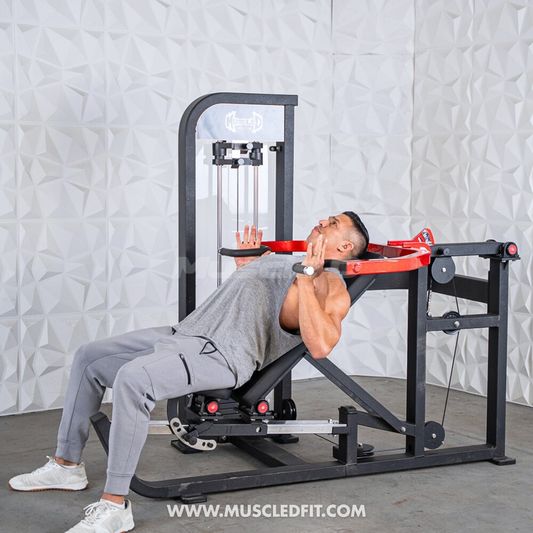 Person using a Classic-V2-Selectorized-Multi-Press-Chest_Shoulder-Press-Machine machine in a room with a textured white wall.