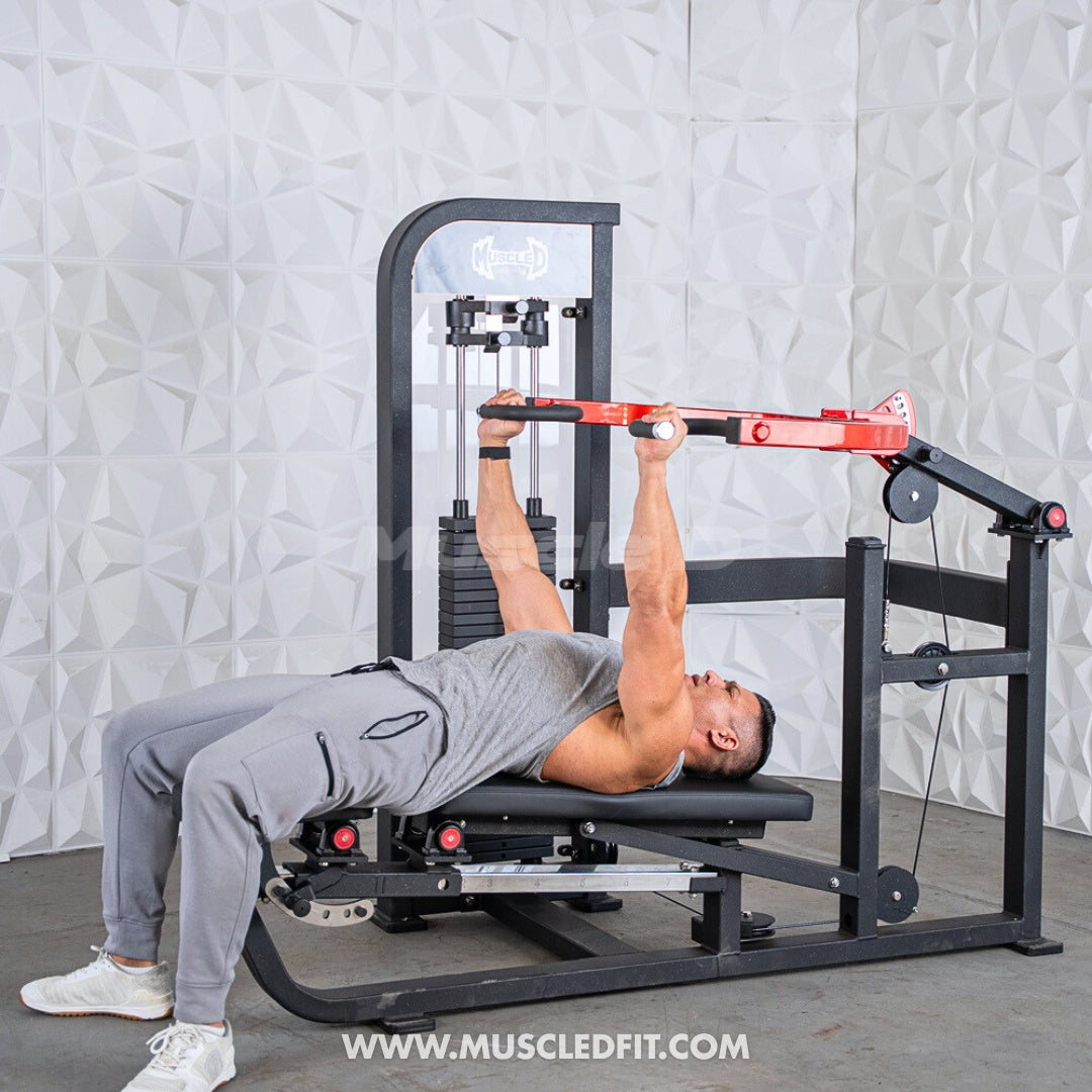 Person using a Classic V2 Selectorized Multi-Press Chest & Shoulder Press machine in a gym setting with a textured white wall background.