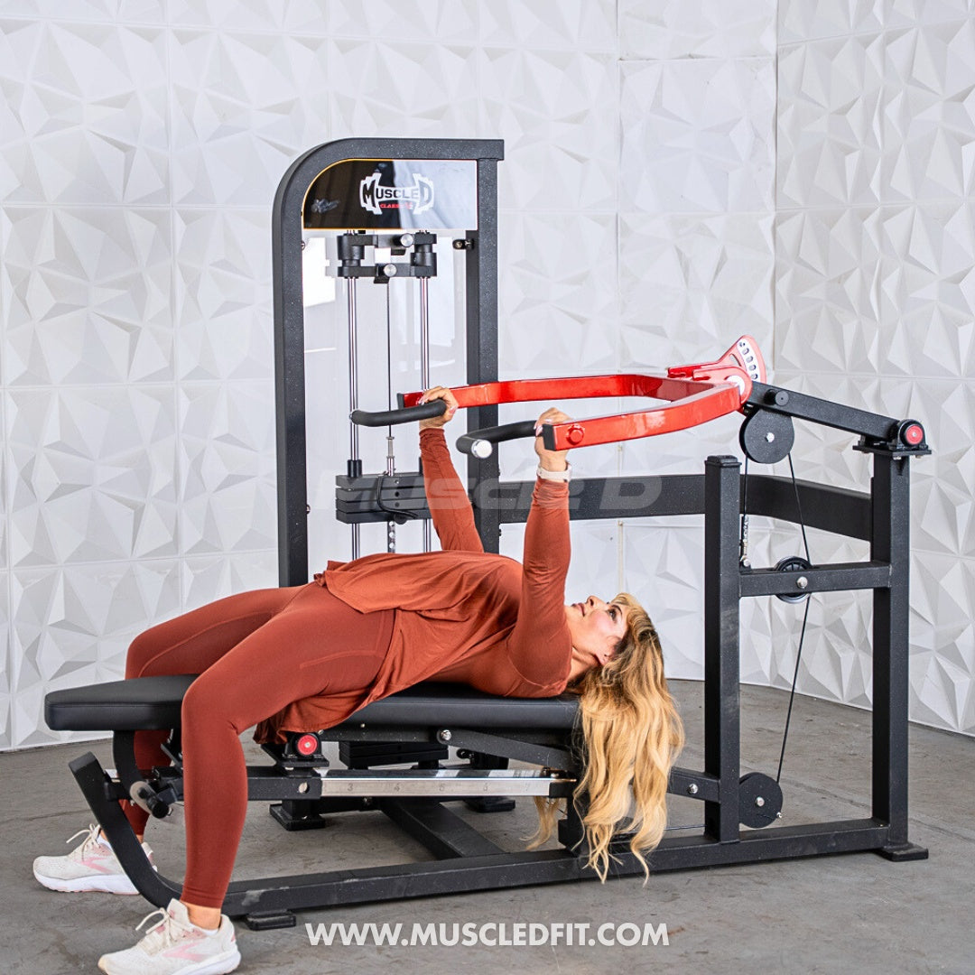 Woman exercising on a Classic V2 Selectorized Multi-Press Chest & Shoulder Press in a gym setting with a textured white wall background.