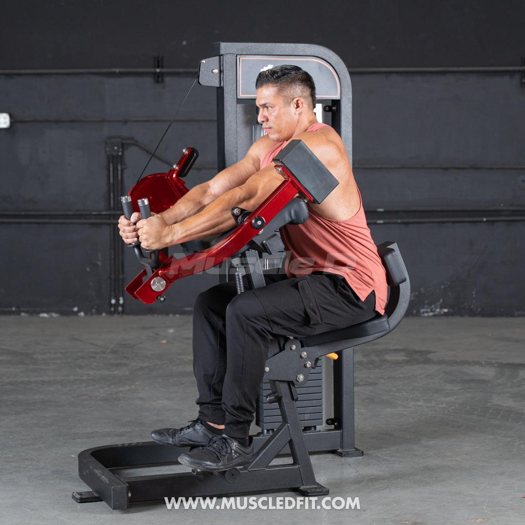 Man exercising on a red Classic V2 Triceps extension machine in a gym setting