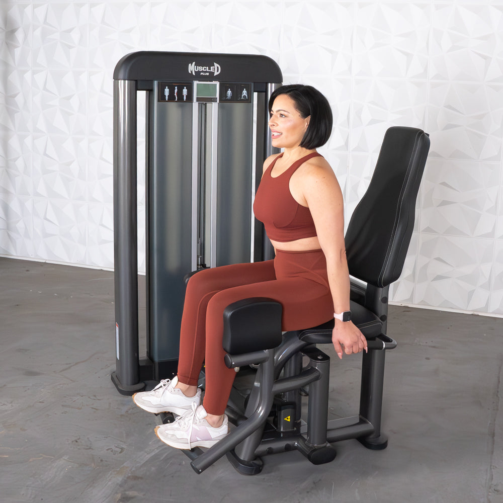 commercial selectorized black and dark grey outer thigh machine
