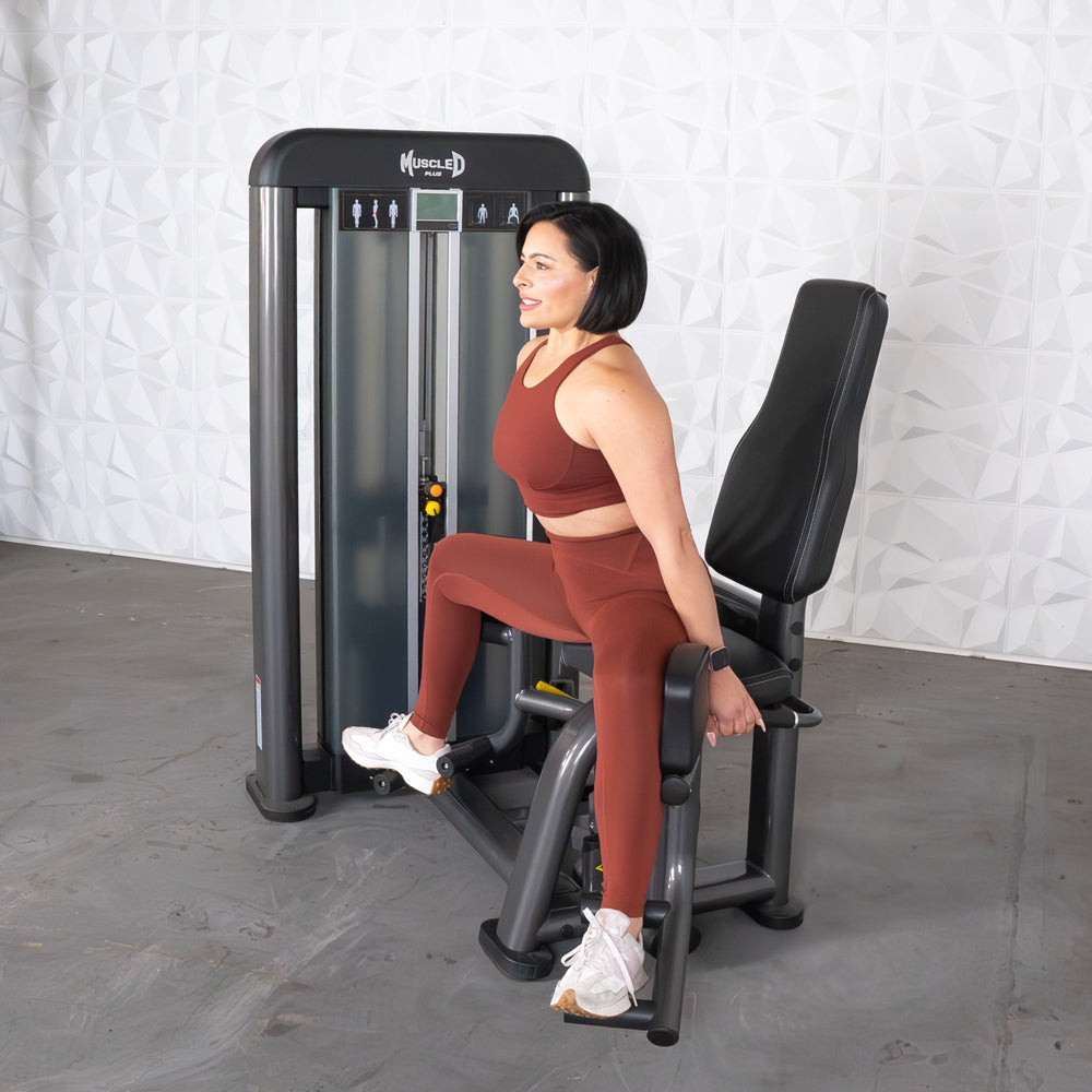 commercial selectorized black and dark grey outer thigh machine