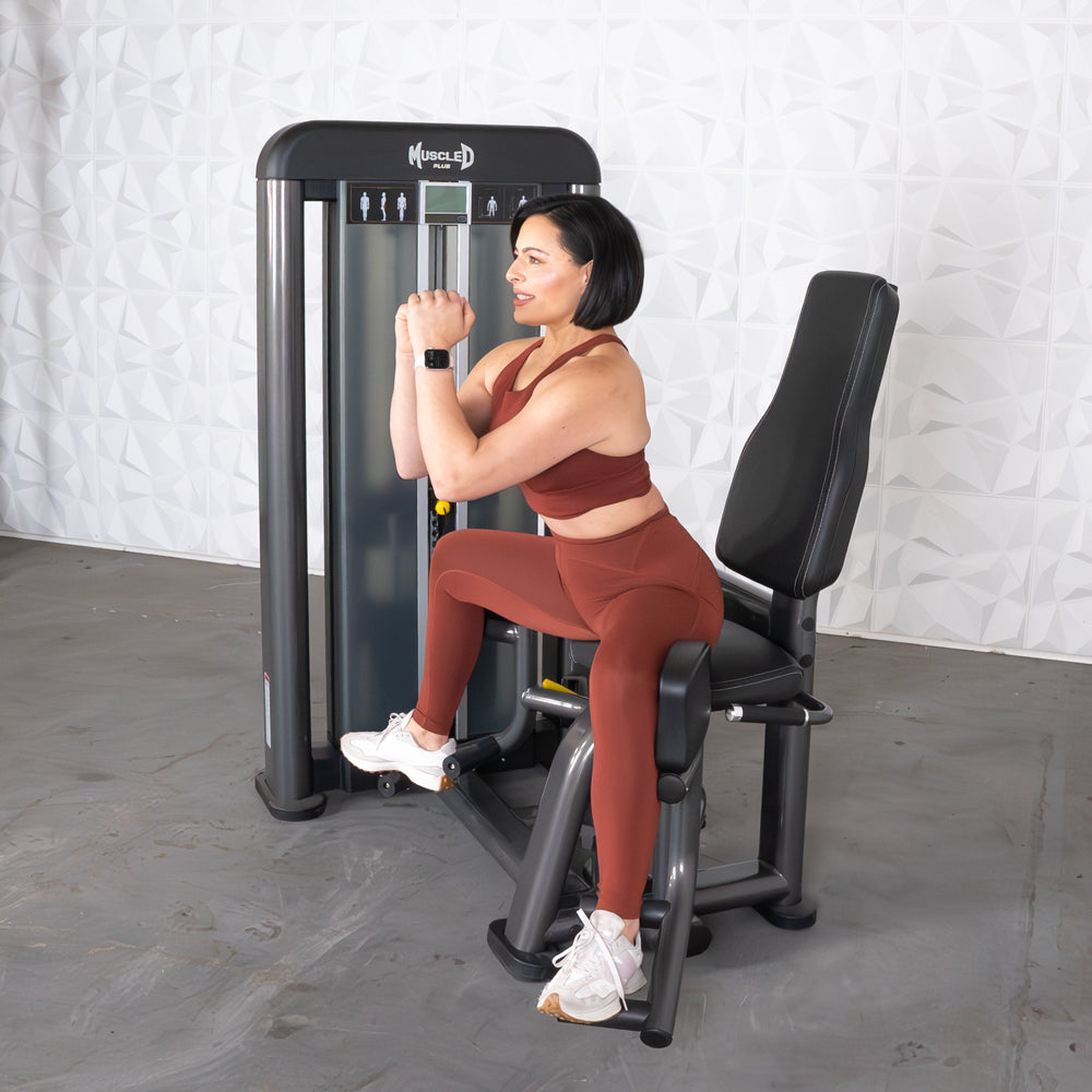 commercial selectorized black and dark grey outer thigh machine