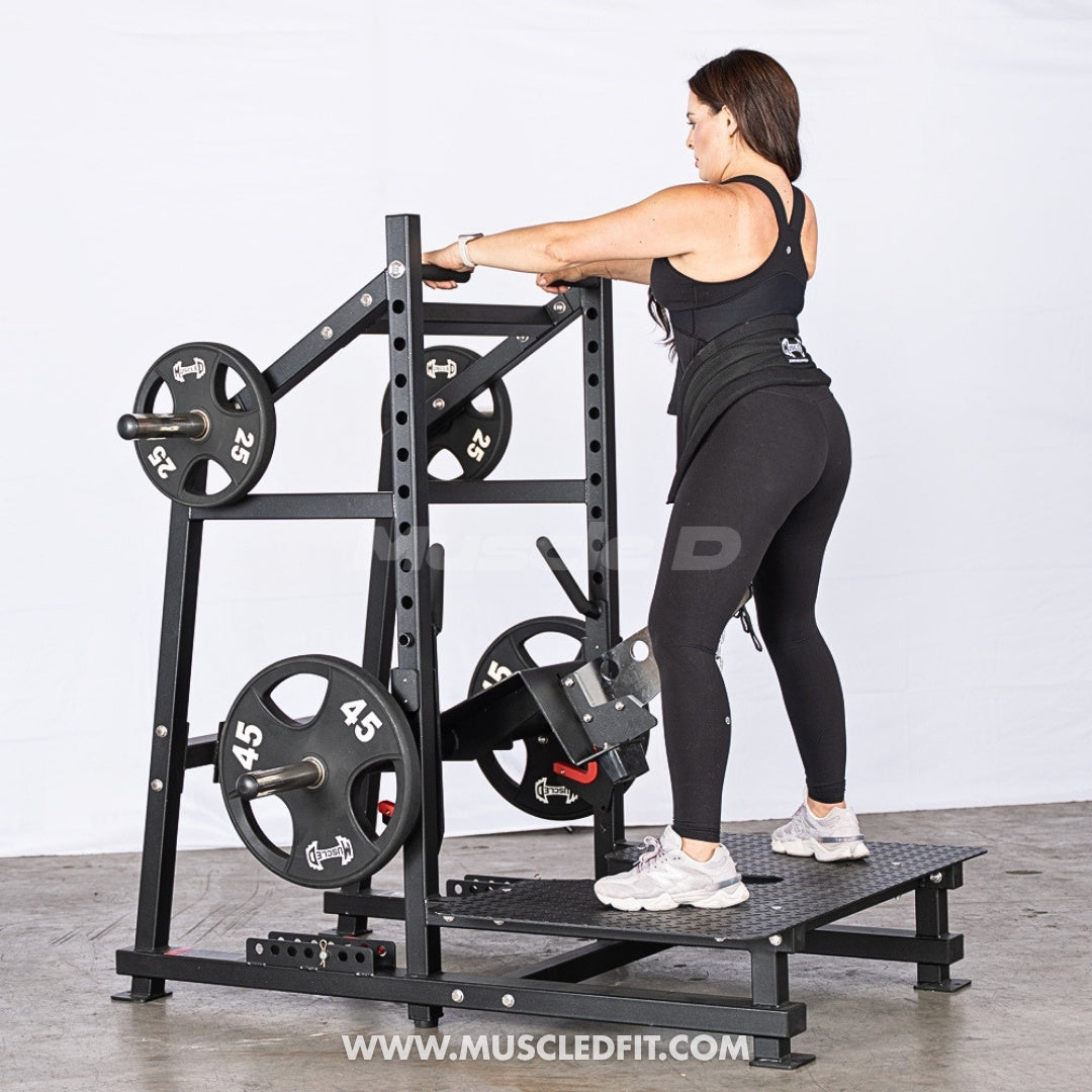 Woman exercising on an Excel Belt Squat machine with a white background