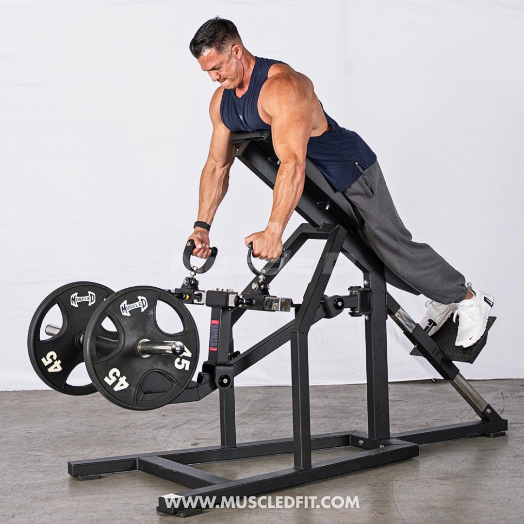 Man exercising on an Excel Chest Supported T-Bar Row machine with weights, wearing a navy tank top and gray pants.