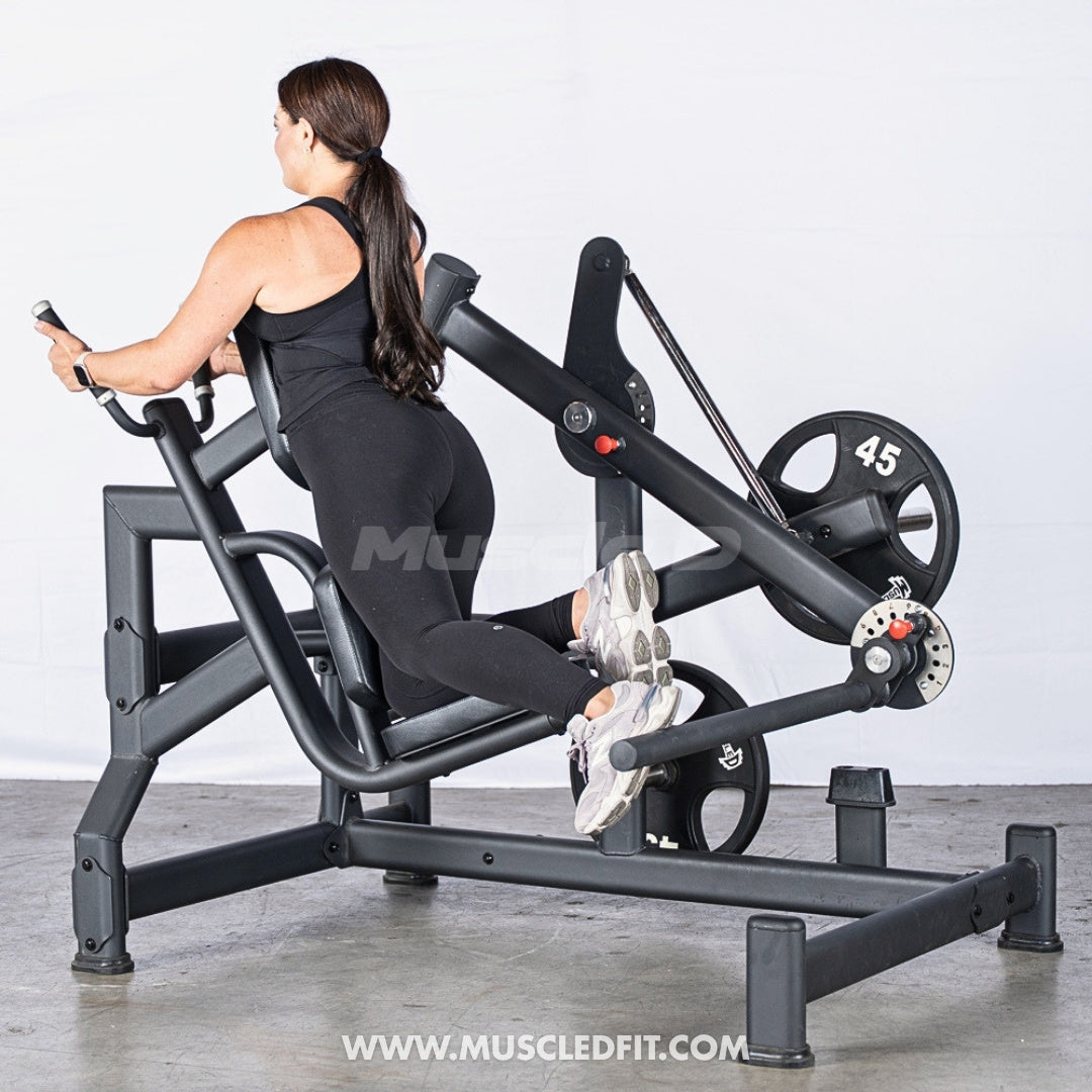 Woman exercising on an Excel Glute Swing machine by Muscle D Fitness in a gym setting