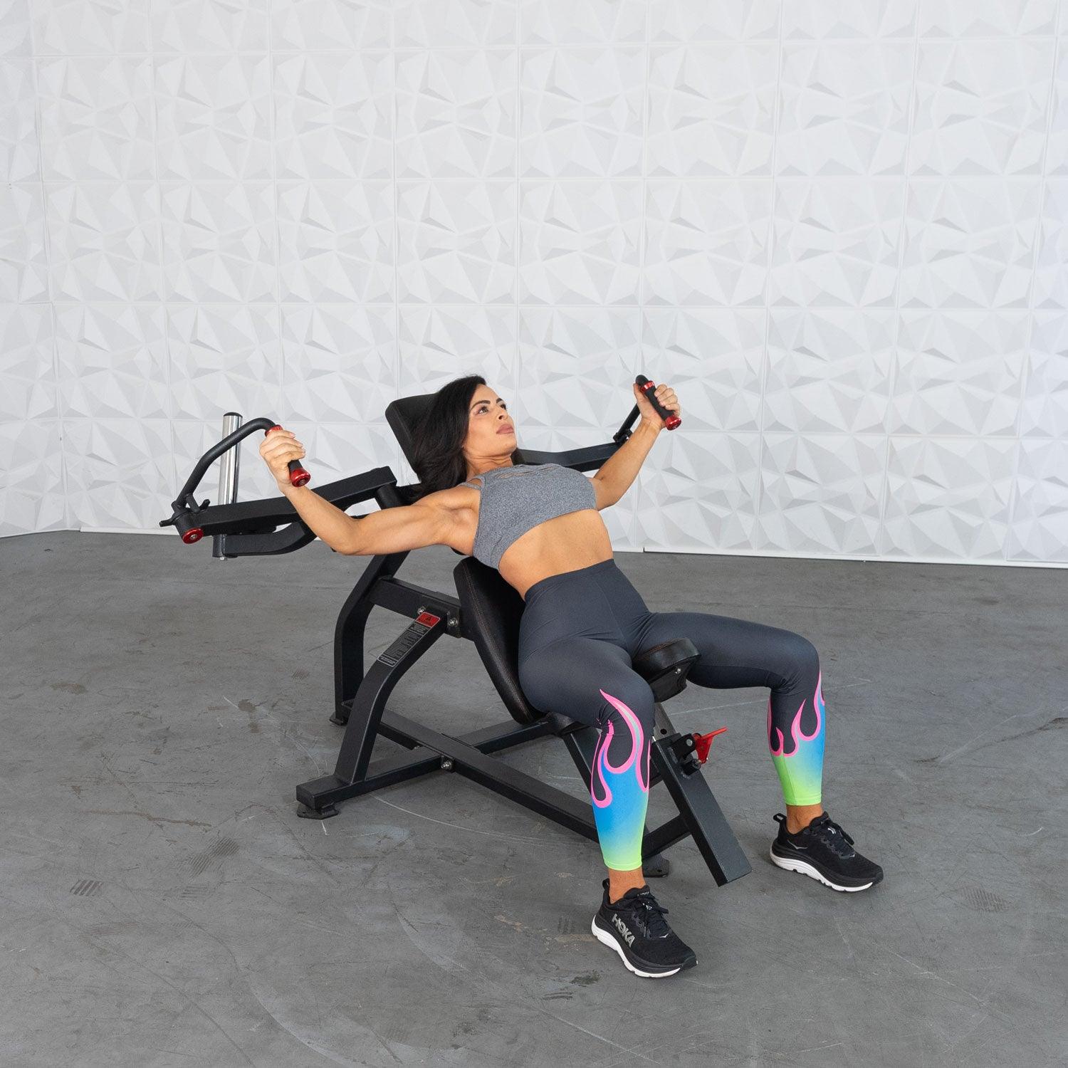 Woman using an Excel Leverage Incline Pec Fly with a white background