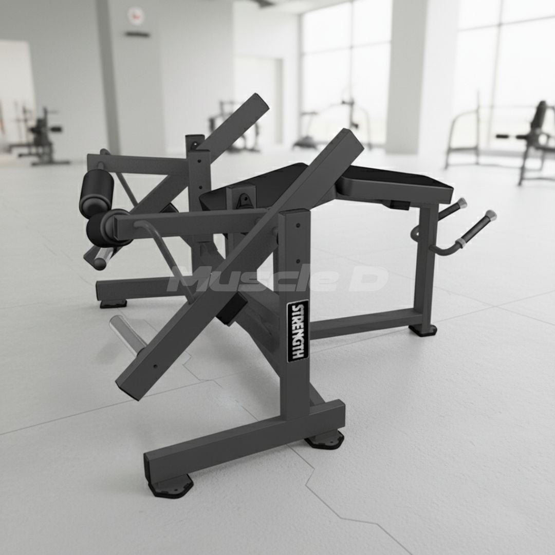 Excel Prone Leg Curl machine with 'Muscle D' branding on a white floor.