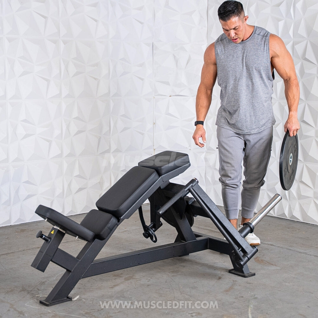 Man loading a weight plate onto a Muscle D Excel Contoured Incline Pec Fly