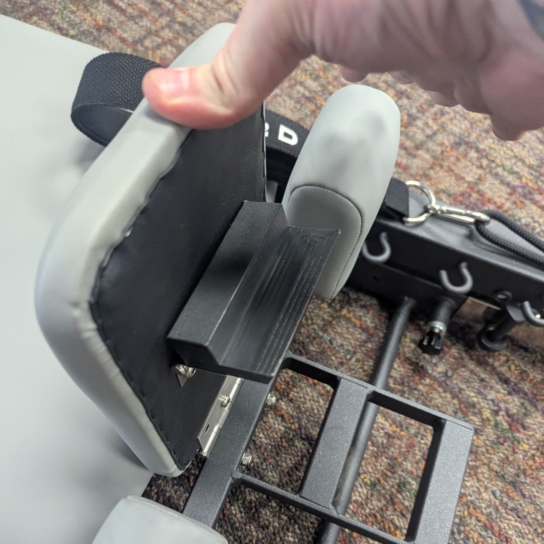 sleek light grey pilates reformer table with padded platform, adjustable foot bar, and sturdy metal frame for home or studio use