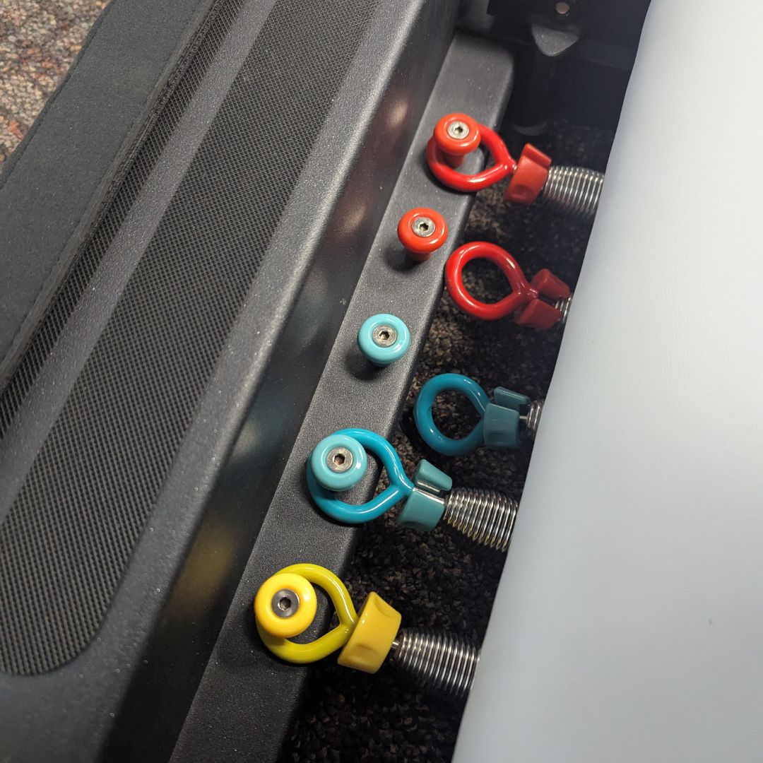 sleek light grey pilates reformer table with padded platform, adjustable foot bar, and sturdy metal frame for home or studio use