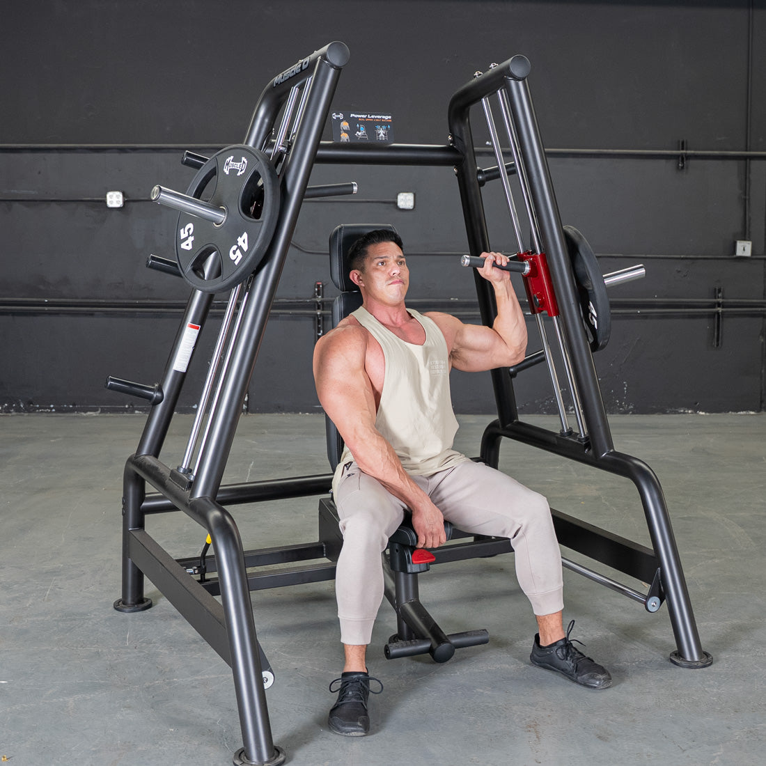 muscle d fitness commercial plate-loaded black and maroon handle power leverage v2 convergent bench machine