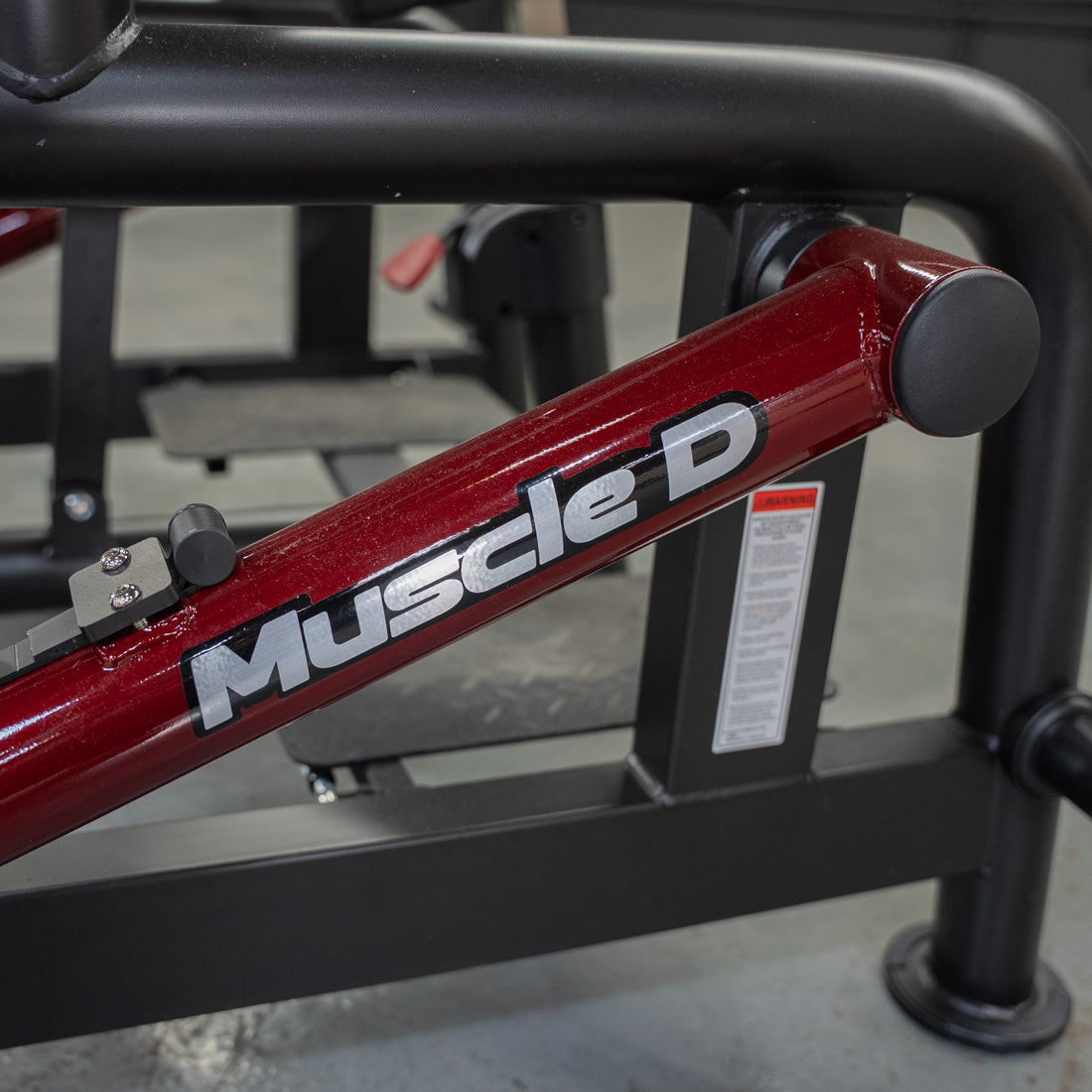 muscle d fitness commercial plate loaded black and maroon power leverage v2 iso lateral biceps curl machine logo detail