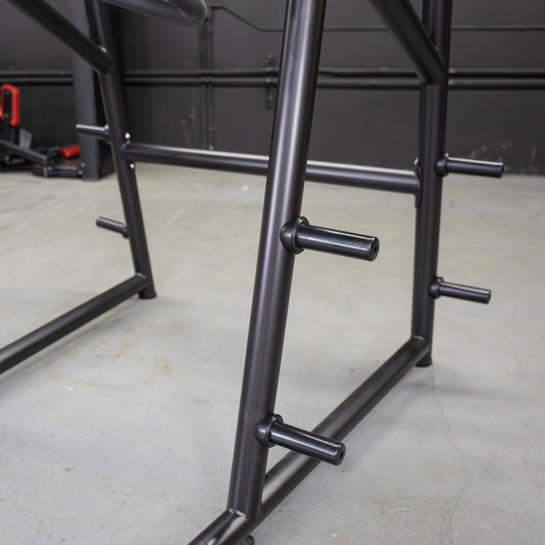 muscle d fitness commercial plate loaded black and maroon power leverage v2 iso lateral jammer machine weight plate storage horns detail