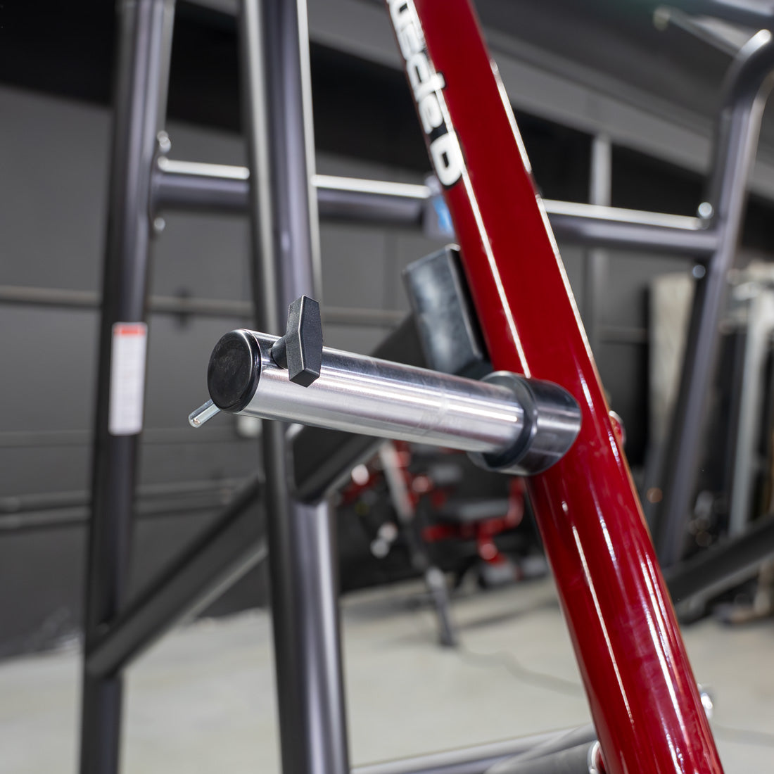 muscle d fitness commercial plate loaded black and maroon power leverage v2 iso lateral jammer machine weight peg detail with safety stop