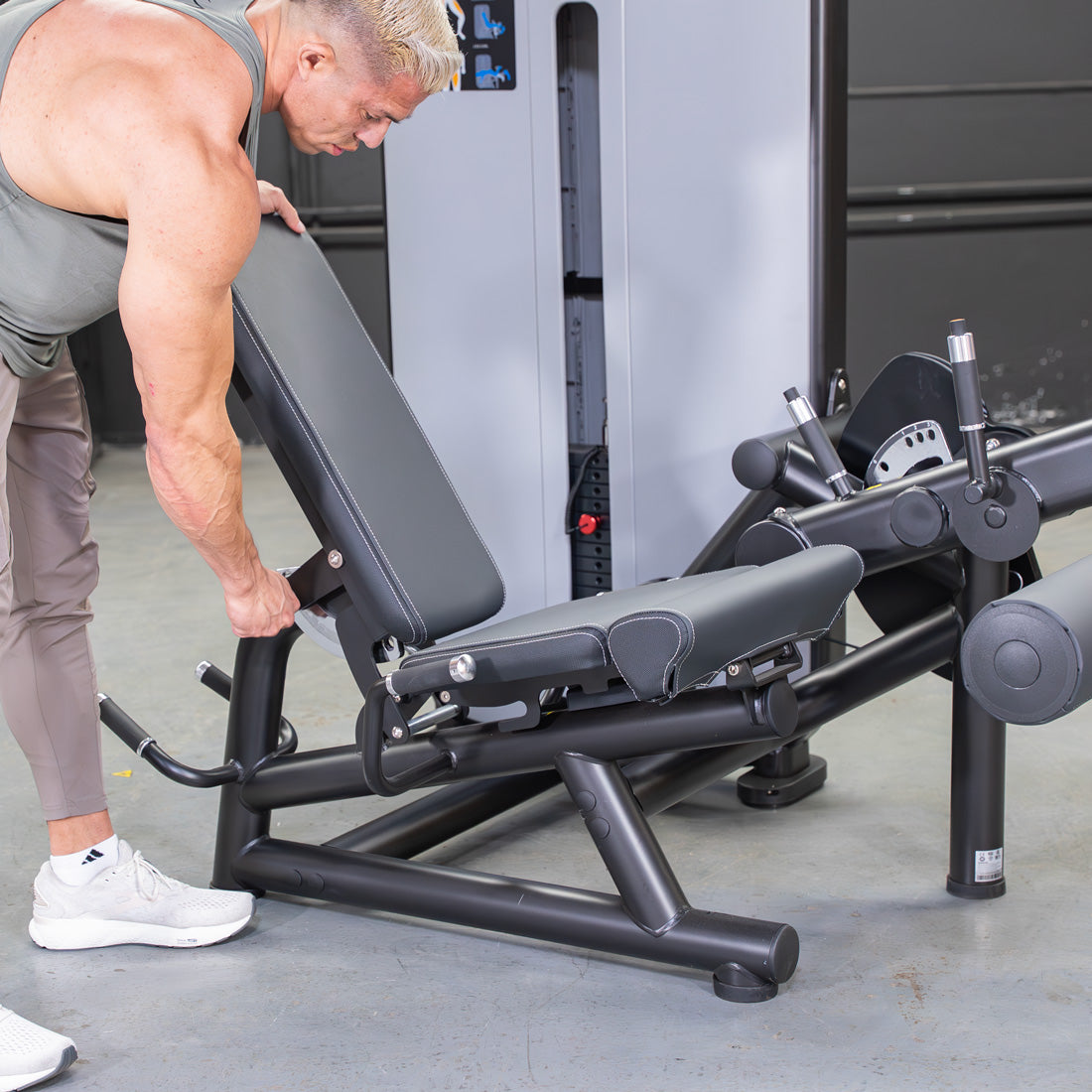 muscle d fitness commercial selectorized vogue black and light grey leg extension prone leg curl combo machine close up