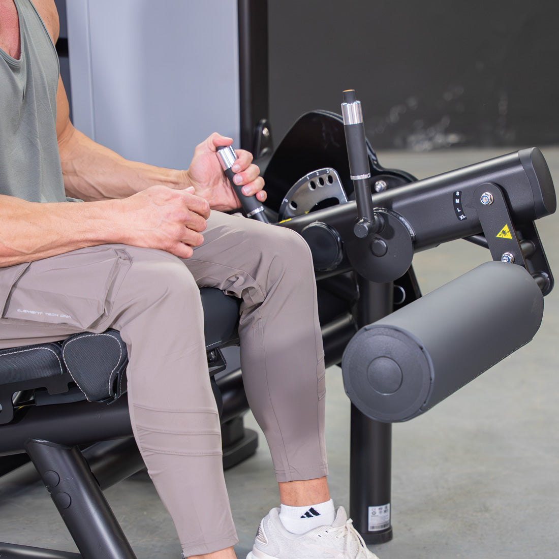 muscle d fitness commercial selectorized vogue black and light grey leg extension prone leg curl combo machine close up