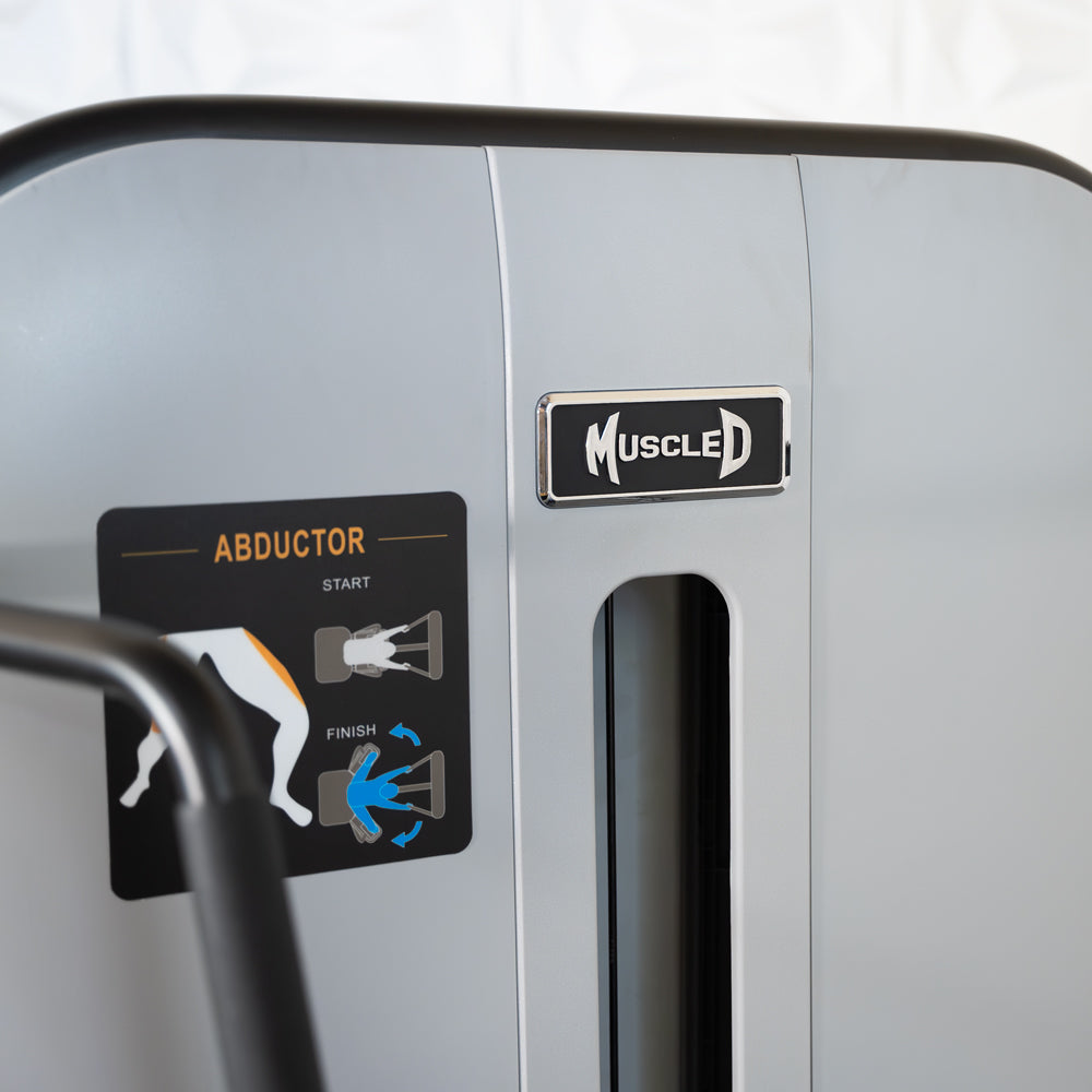 commercial grade black and white selectorized standing abductor machine detail