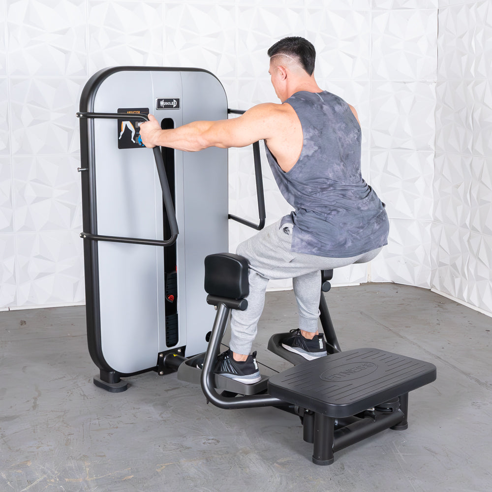 commercial grade black and white selectorized standing abductor machine