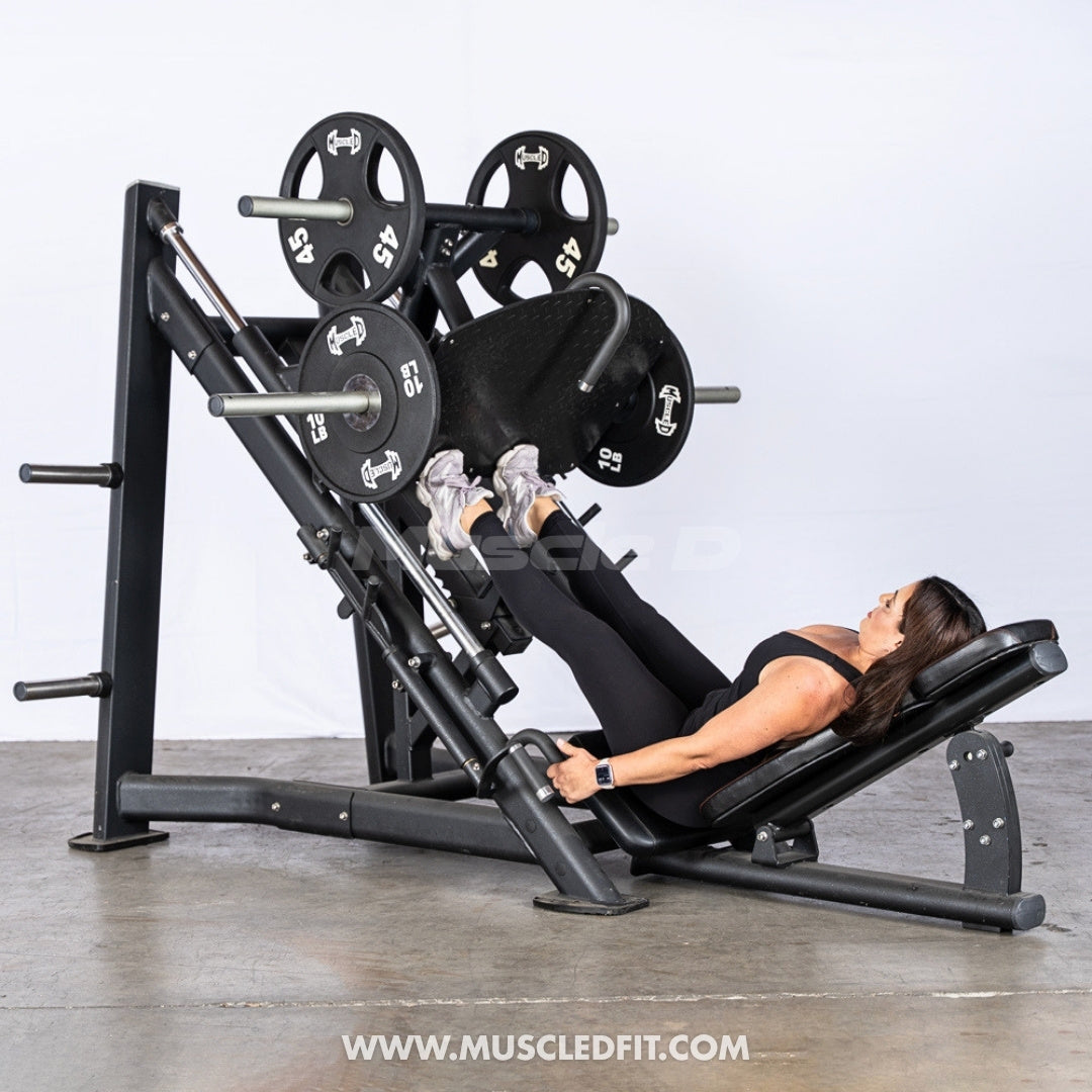 Person using an Excel Leg Press machine by Muscle D Fitness in a gym setting with a white background