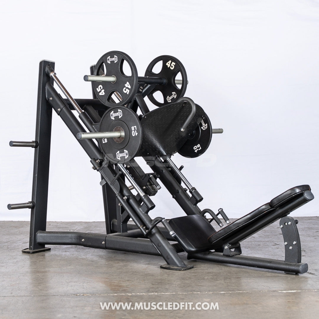 45 Degree Leg press machine with weights on a concrete floor, brand 'Muscle D Fit' visible.