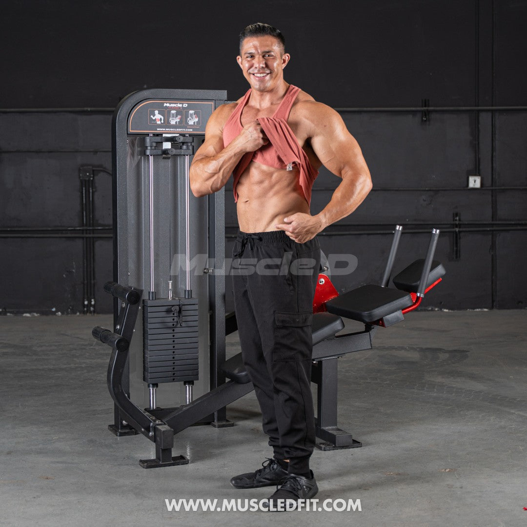 Muscular man posing in a gym with 'Muscle Fit' branding.