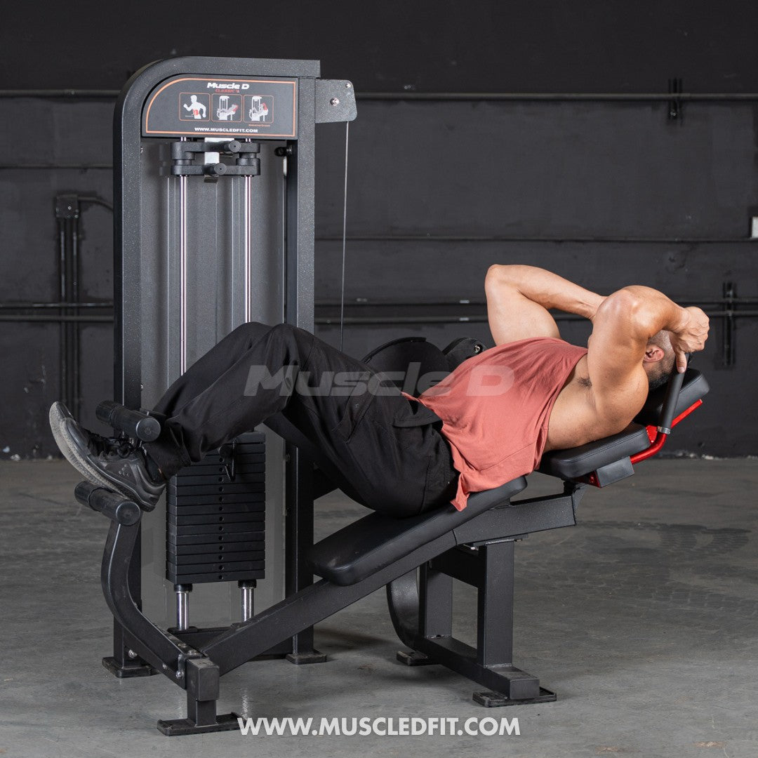 Person using a Classic V2 Abdominal Crunch machine with 'Muscle D Fit' branding in the background.