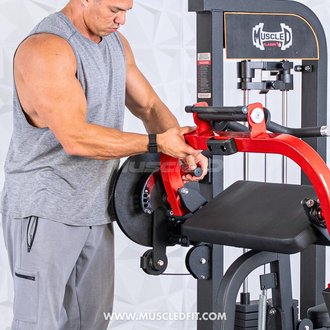 Man using a red and black Classic V2 Biceps/Triceps machine with 'MuscleD Fit' branding.