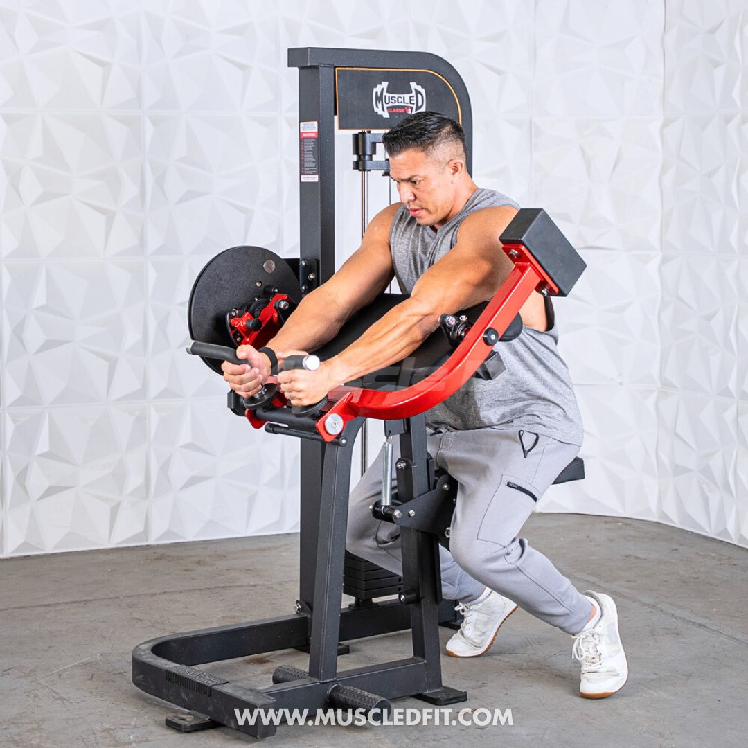 Man using a Classic V2 Biceps/Triceps machine with a white wall background