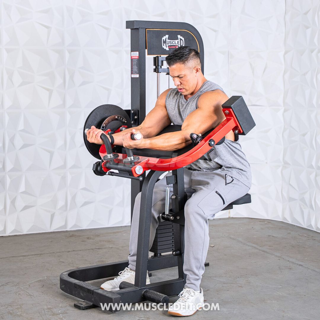 Man exercising on a Classic V2 Biceps/Triceps machine with a white textured wall background