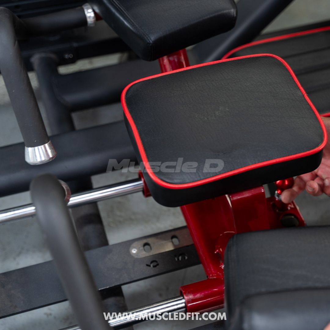 Close-up of a red and black Classic V2 Glute Kick machine with 'Muscle D' branding.