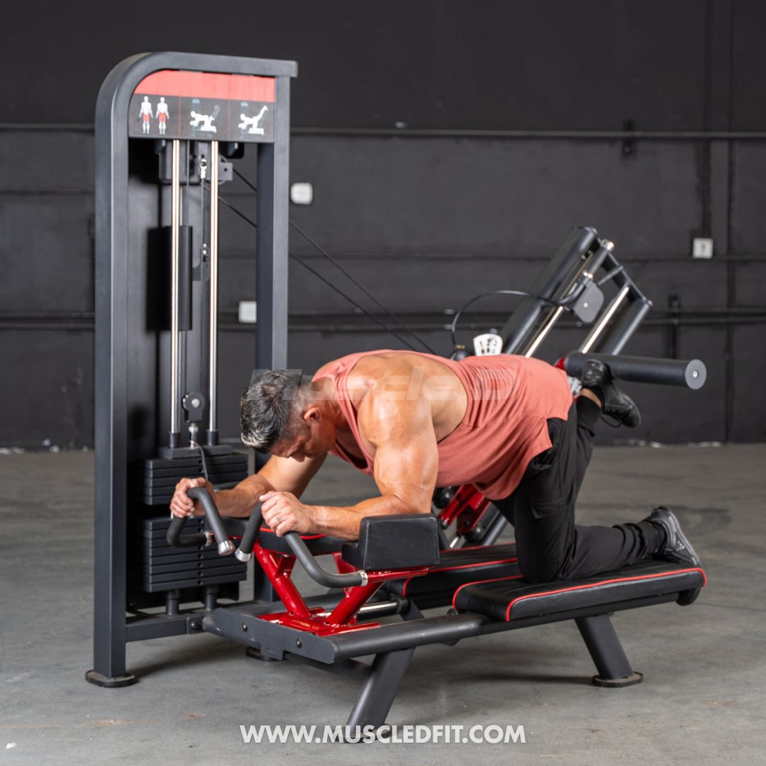Man exercising on a Classic V2 Glute Kick machine in a gym setting with 'MuscleDFit' branding.