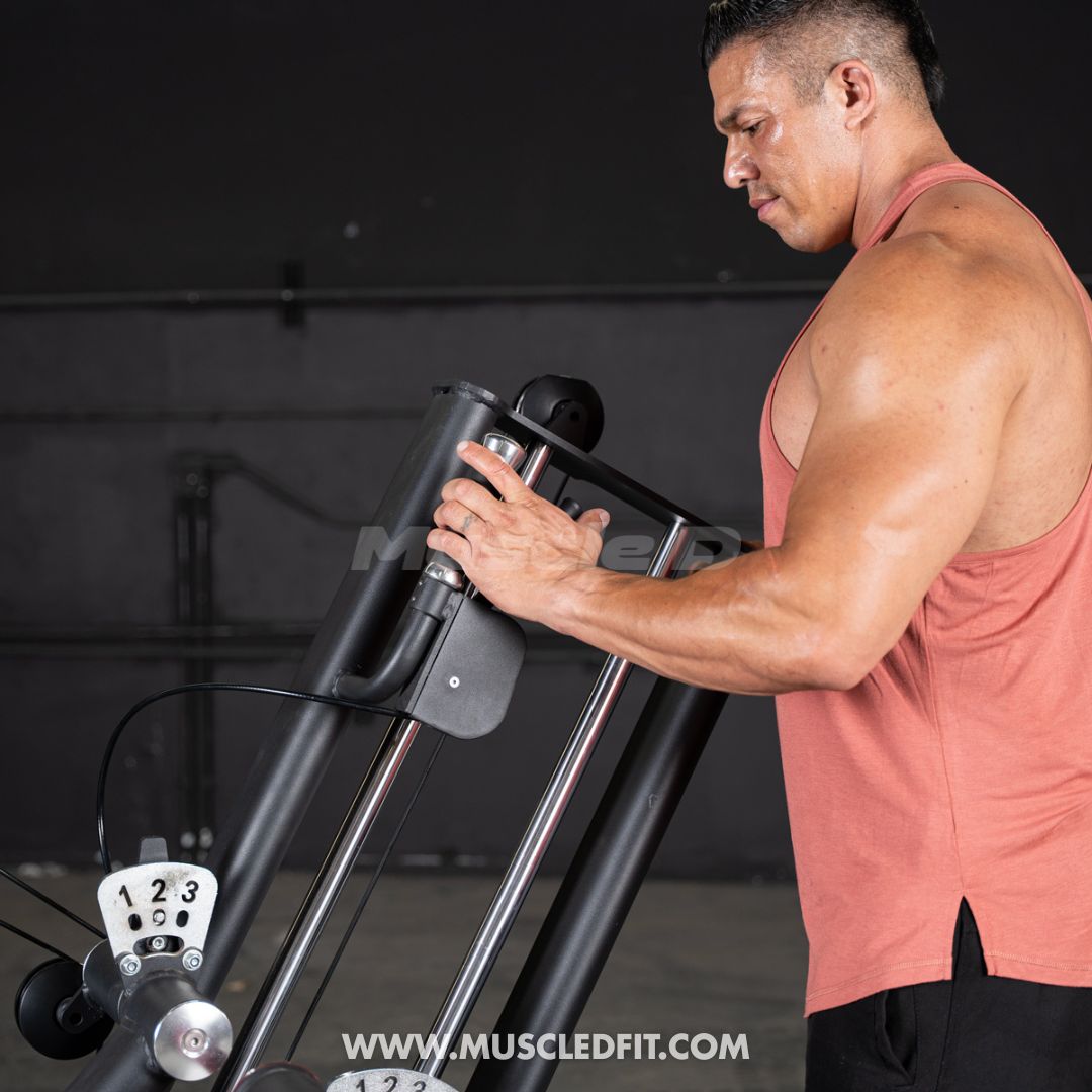 Man adjusting a Classic V2 Glute Kick equipment in a gym setting