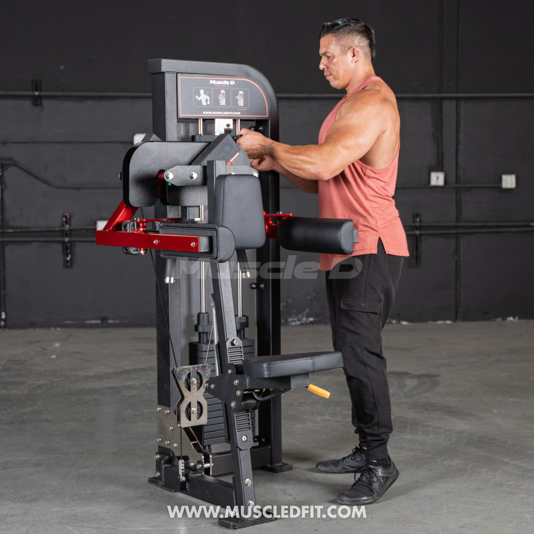 Man using a Muscle D Lateral Raise  machine in a fitness setting with 'MuscleD Fit' branding.