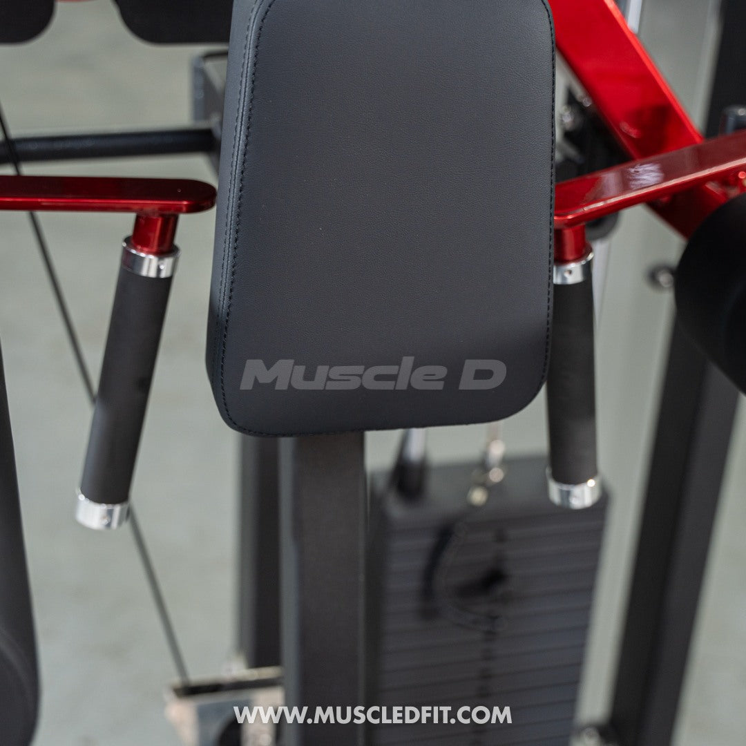 Close-up of a Muscle D Lateral Raise  machine with 'Muscle D' branding on a blurred background