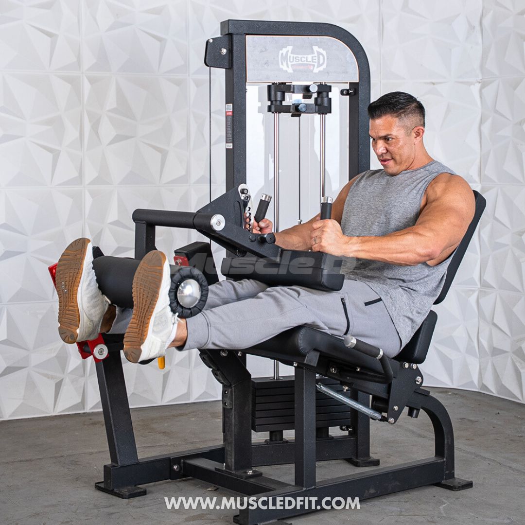 Man exercising on a Classic V2 Selectorized Leg Extension / Seated Leg Curl Combo machine in a gym setting