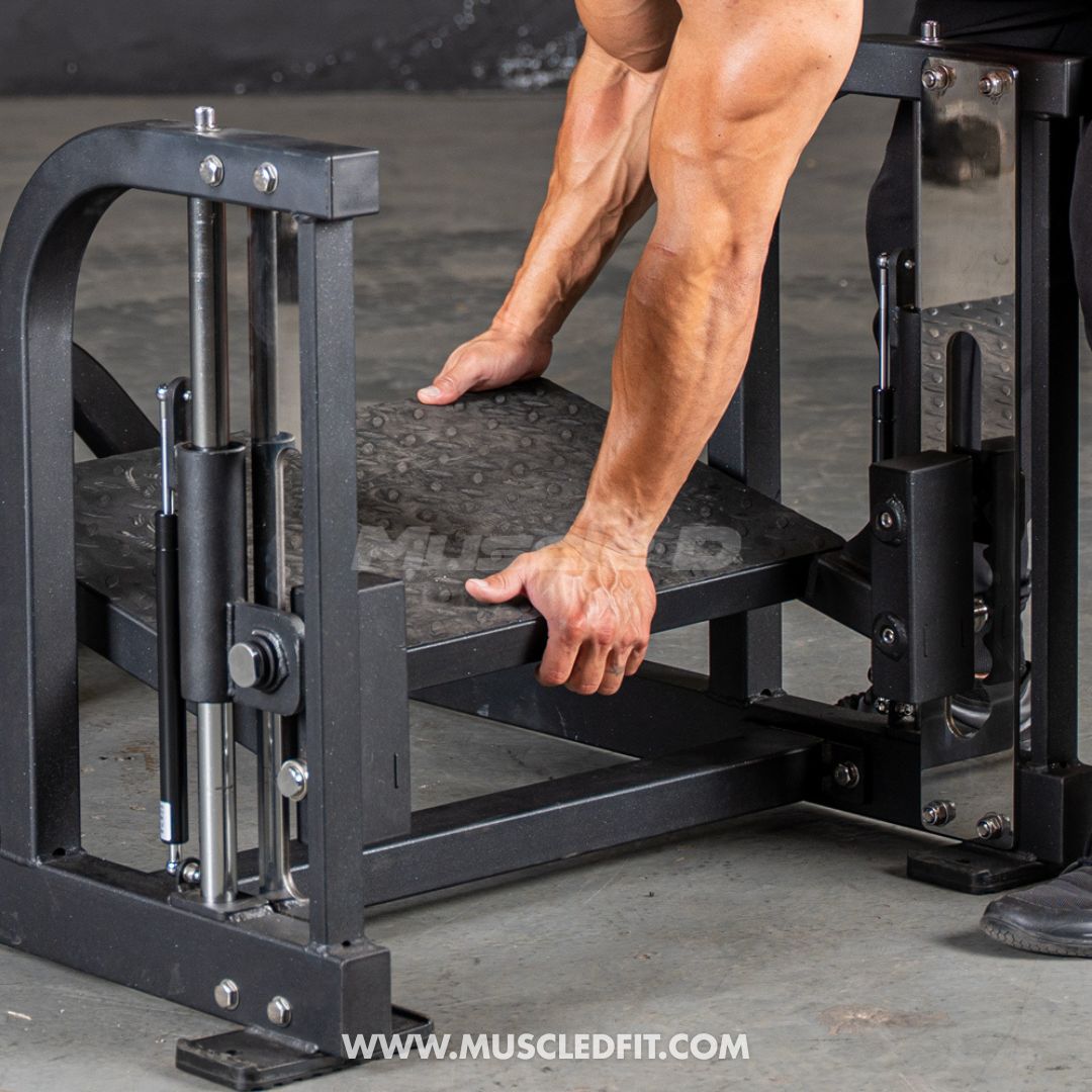 Person using a Classic V2 Multi Hip  machine in a gym setting with 'www.muscledfit.com' branding.