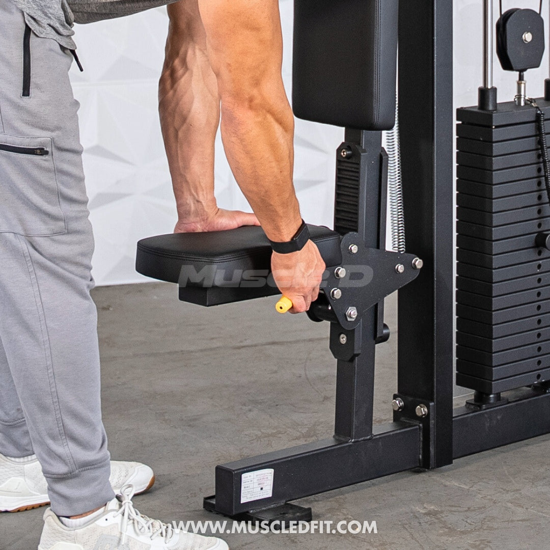 Person using a Classic V2 Pec/Rear Delt Combo machine with 'MuscleFit' branding on a gray floor.