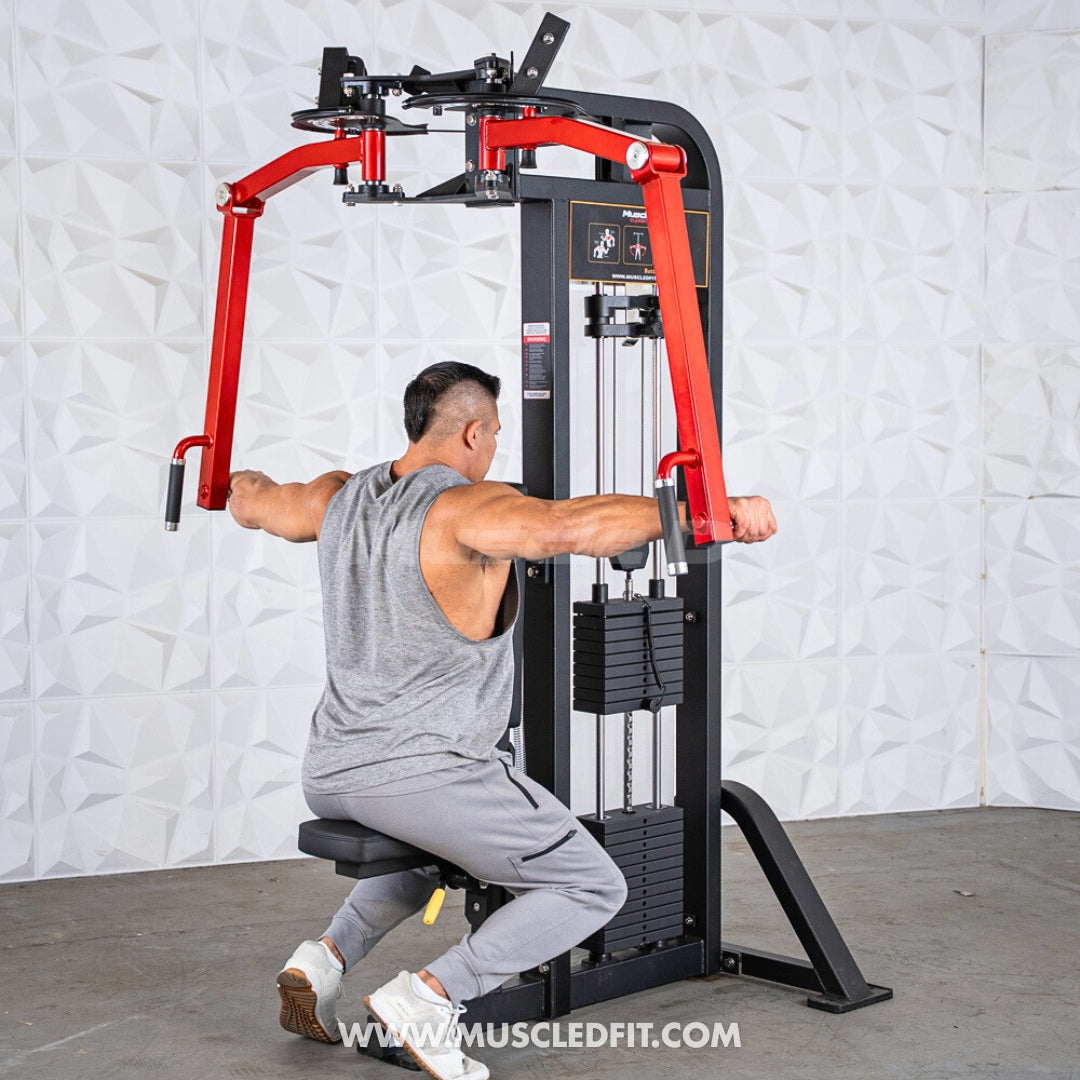 Man using a red and black Classic V2 Pec/Rear Delt Combo machine in a gym setting