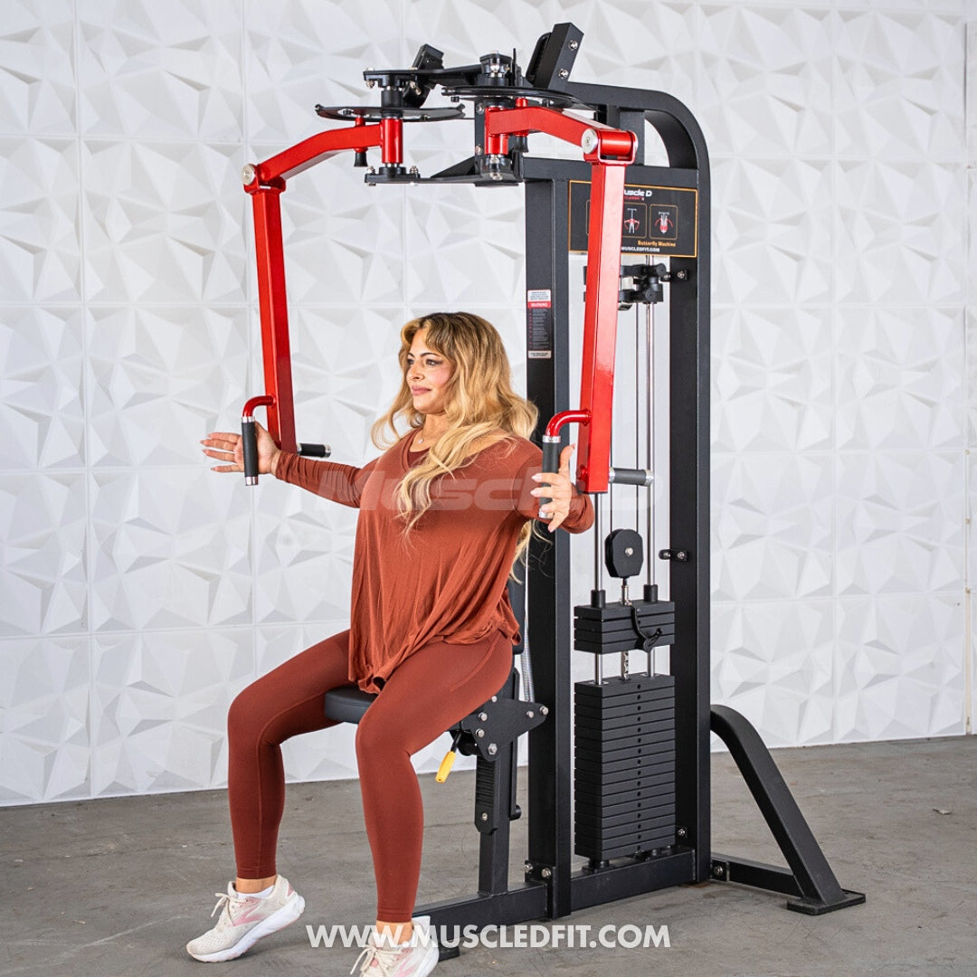 Woman exercising on a red-and-black Classic V2 Pec/Rear Delt Combo machine against a white, textured wall.