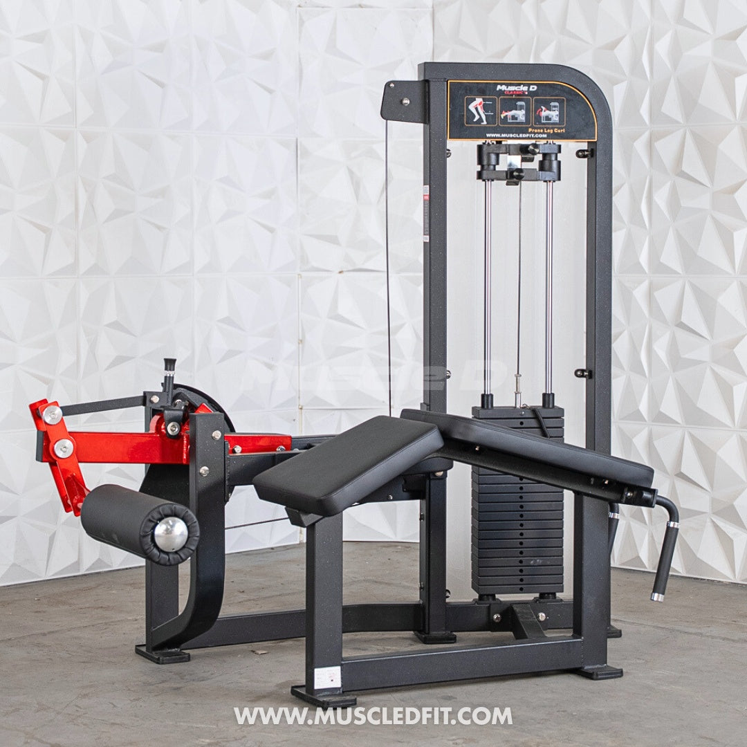  Classic V2 Prone Leg Curl machine with red and black components on a textured white wall background