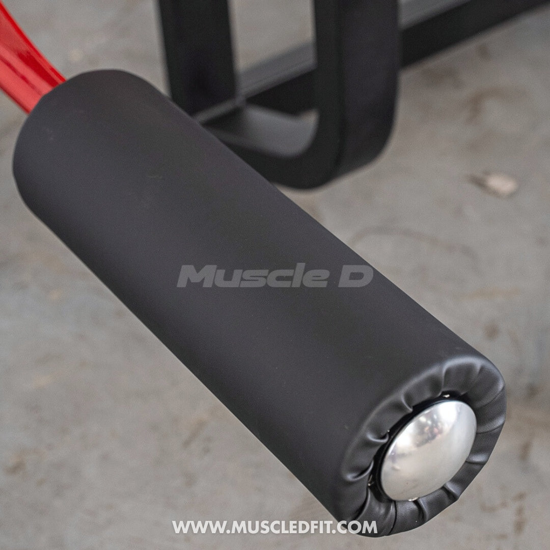 Close-up of a  Classic V2 Prone Leg Curl with 'Muscle D' branding on a concrete floor.