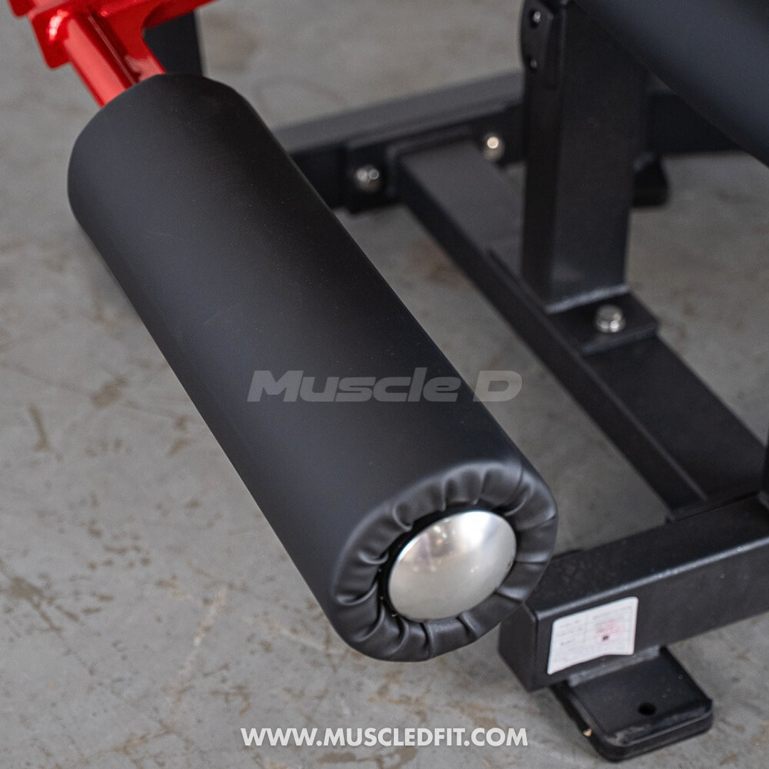 Classic V2 Seated Leg Curl  with black padding and visible 'Muscle D' branding on a concrete floor.