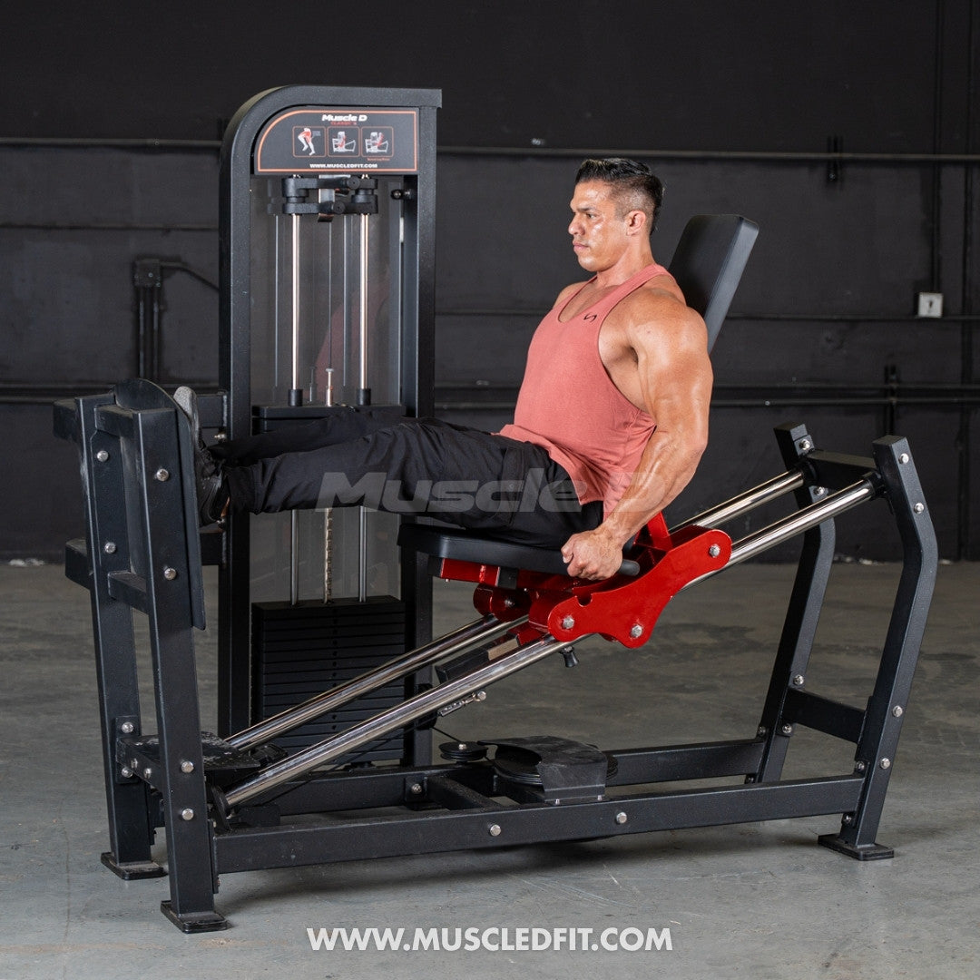 Man exercising on a Classic V2 Selectorized Leg Press machine in a gym setting