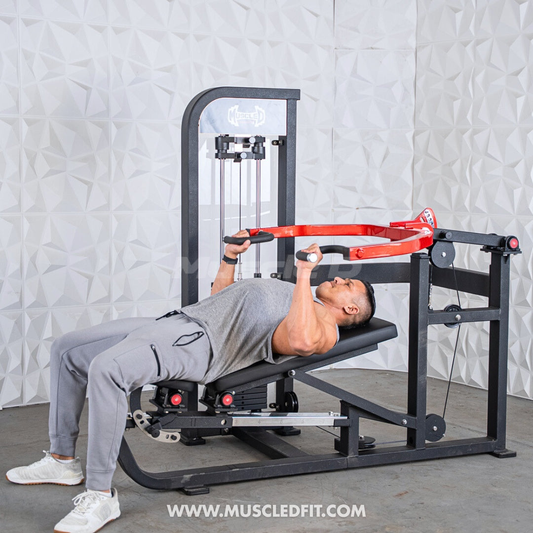 Person using a Classic V2 Selectorized Multi-Press Chest & Shoulder Press machine in a well-lit room with a textured wall.