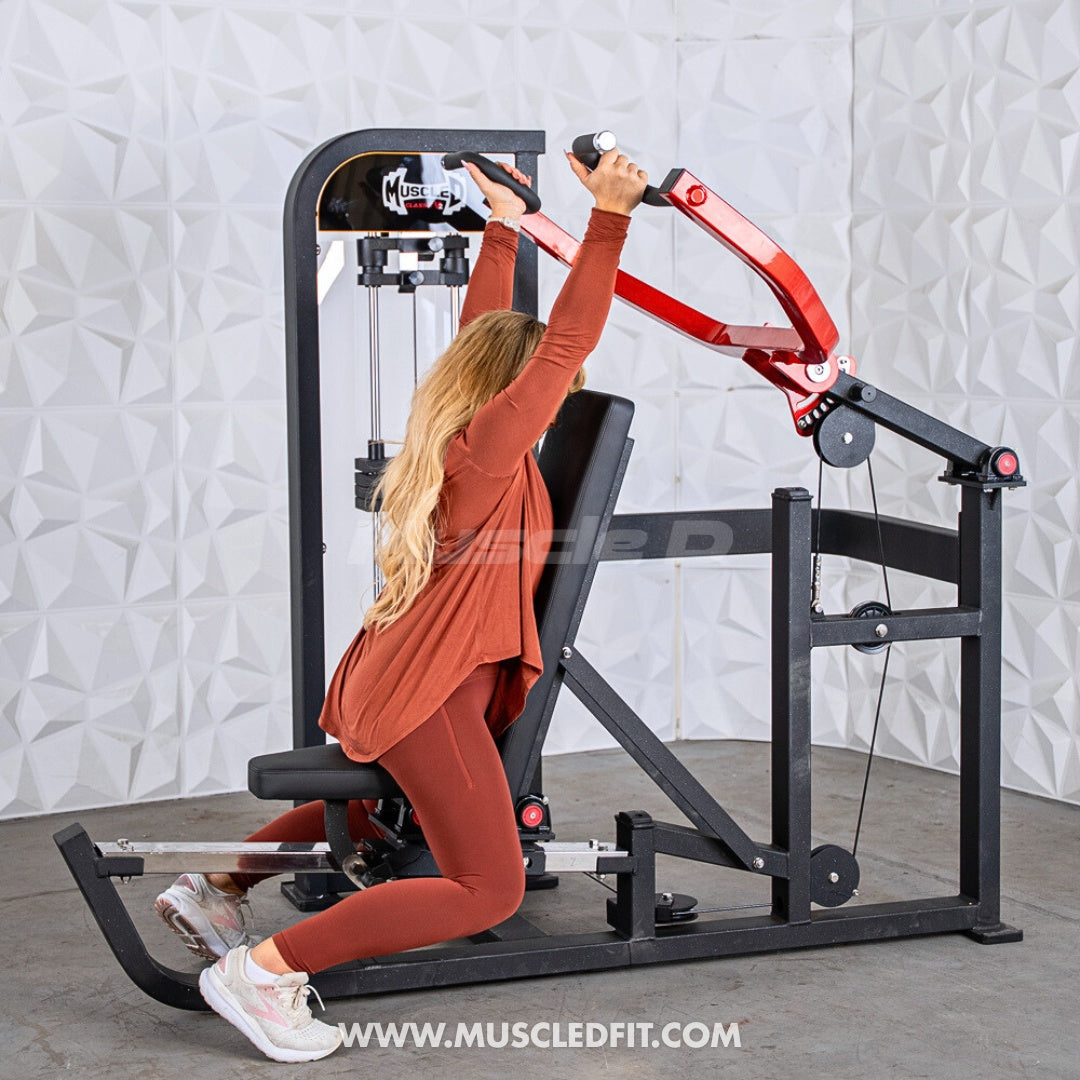 Person using a Classic V2 Selectorized Multi-Press Chest & Shoulder Press machine with a textured white wall background